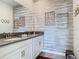 Double vanity bathroom with gray countertop and patterned wall at 4563 Narrative Ln, Kissimmee, FL 34746