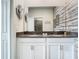 Double vanity bathroom with gray countertop and patterned wall at 4563 Narrative Ln, Kissimmee, FL 34746