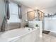 Spa-like bathroom with soaking tub and walk-in shower at 4563 Narrative Ln, Kissimmee, FL 34746