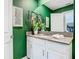 Modern bathroom with white vanity and green walls at 4563 Narrative Ln, Kissimmee, FL 34746