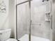 Shower stall with glass enclosure and gray tile at 4563 Narrative Ln, Kissimmee, FL 34746