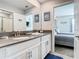 Clean bathroom with double vanity and a view of a bedroom at 4563 Narrative Ln, Kissimmee, FL 34746