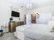 Bright bedroom with a king-size bed, dresser, and TV at 4563 Narrative Ln, Kissimmee, FL 34746