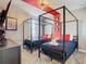 Bedroom with twin beds, a red accent wall, and plenty of natural light at 4563 Narrative Ln, Kissimmee, FL 34746