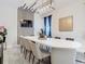 Modern dining room with large white table and statement wall decor at 4563 Narrative Ln, Kissimmee, FL 34746