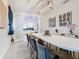 Bright dining room with white table, kitchen view, and elegant decor at 4563 Narrative Ln, Kissimmee, FL 34746
