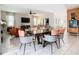Open concept dining area with dark wood table and orange accents at 4563 Narrative Ln, Kissimmee, FL 34746