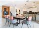 Open concept dining area with dark wood table and pink chairs at 4563 Narrative Ln, Kissimmee, FL 34746