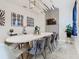Stylish dining room featuring a white oval table and modern art at 4563 Narrative Ln, Kissimmee, FL 34746