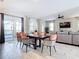 Dining area with dark wood table, pool view, and modern chairs at 4563 Narrative Ln, Kissimmee, FL 34746