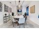 Elegant dining room with a white table and modern chairs at 4563 Narrative Ln, Kissimmee, FL 34746