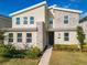 Two story home with stone and light colored siding at 4563 Narrative Ln, Kissimmee, FL 34746