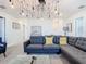 Game room with sectional sofa and a statement light fixture at 4563 Narrative Ln, Kissimmee, FL 34746