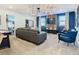 Cozy game room featuring a sectional sofa and a large TV at 4563 Narrative Ln, Kissimmee, FL 34746