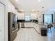 Modern kitchen with stainless steel appliances and an island at 4563 Narrative Ln, Kissimmee, FL 34746