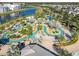 Community pool with a lazy river and plenty of seating at 4563 Narrative Ln, Kissimmee, FL 34746