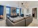 Spacious living room featuring comfortable seating, a large TV, and stylish decor at 4563 Narrative Ln, Kissimmee, FL 34746