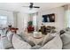 Spacious living room with sectional sofa and a large TV at 4563 Narrative Ln, Kissimmee, FL 34746