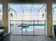 Screened patio with pool, spa, and seating area at 4563 Narrative Ln, Kissimmee, FL 34746