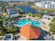 Community pool with a large deck and cabana at 4563 Narrative Ln, Kissimmee, FL 34746