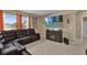 Spacious living room featuring a large TV and comfortable leather sectional sofa at 1823 Laredo Dr, Deltona, FL 32738