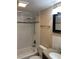 Clean bathroom with tub shower, tile walls, and granite vanity at 327 Scottsdale Sq # 327, Winter Park, FL 32792