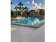 Inviting community pool surrounded by lush landscaping at 327 Scottsdale Sq # 327, Winter Park, FL 32792