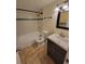 Clean bathroom with tub, toilet and dark vanity at 347 Scottsdale Sq # 347, Winter Park, FL 32792