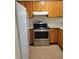 Modern kitchen featuring stainless steel appliances and wood cabinets at 347 Scottsdale Sq # 347, Winter Park, FL 32792