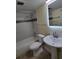 Clean bathroom with a bathtub, toilet and pedestal sink at 348 Scottsdale Sq # 348, Winter Park, FL 32792