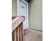 White front door entrance with wooden steps and a welcome mat at 348 Scottsdale Sq # 348, Winter Park, FL 32792