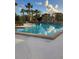 Inviting community pool surrounded by lush landscaping at 348 Scottsdale Sq # 348, Winter Park, FL 32792