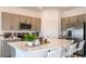 Modern kitchen with stainless steel appliances and an island with seating at 3557 Mayfair St, Kissimmee, FL 34758