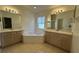 Large bathroom with double vanities, corner soaking tub, and separate shower at 5453 Shingle Creek Dr, Orlando, FL 32821