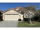 Tan two-story house with a beige garage door and landscaping at 5453 Shingle Creek Dr, Orlando, FL 32821
