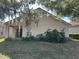Tan house exterior with covered patio and lush landscaping at 5453 Shingle Creek Dr, Orlando, FL 32821