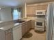 Kitchen with light wood cabinets and white appliances at 5453 Shingle Creek Dr, Orlando, FL 32821