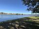 Stunning lake view with clear blue water and a beautiful homescape at 5453 Shingle Creek Dr, Orlando, FL 32821
