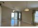 Bright living room with vaulted ceiling, tile floors, and sliding glass doors leading to a patio at 5453 Shingle Creek Dr, Orlando, FL 32821
