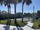 Community tennis court with surrounding fence and palm trees at 5453 Shingle Creek Dr, Orlando, FL 32821
