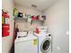 Laundry room with washer, dryer, and ample storage at 5506 Willow Bend Trl, Kissimmee, FL 34758