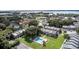 Aerial view showing community pool, tennis court, and townhouses at 5850 Cypress Gardens Blvd # 304, Winter Haven, FL 33884