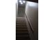 Staircase with wooden handrail and lighting at 5850 Cypress Gardens Blvd # 304, Winter Haven, FL 33884