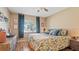 Bright bedroom with a queen bed and wood floors at 6110 Curry Ford Rd # 219, Orlando, FL 32822