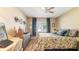 Bright bedroom with a queen bed and wood floors at 6110 Curry Ford Rd # 219, Orlando, FL 32822
