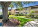 Attractive condo building with lush landscaping and a walkway at 6110 Curry Ford Rd # 219, Orlando, FL 32822