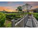 Wooden footbridge over a tranquil waterway at sunset at 6110 Curry Ford Rd # 219, Orlando, FL 32822