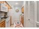 Bright kitchen with white appliances and wood cabinets at 6110 Curry Ford Rd # 219, Orlando, FL 32822
