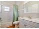 Simple bathroom with tub, shower, and white vanity at 839 Franconville Ct, Kissimmee, FL 34759