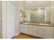 Bathroom boasts double vanity, large mirror, and tile floor at 839 Franconville Ct, Kissimmee, FL 34759